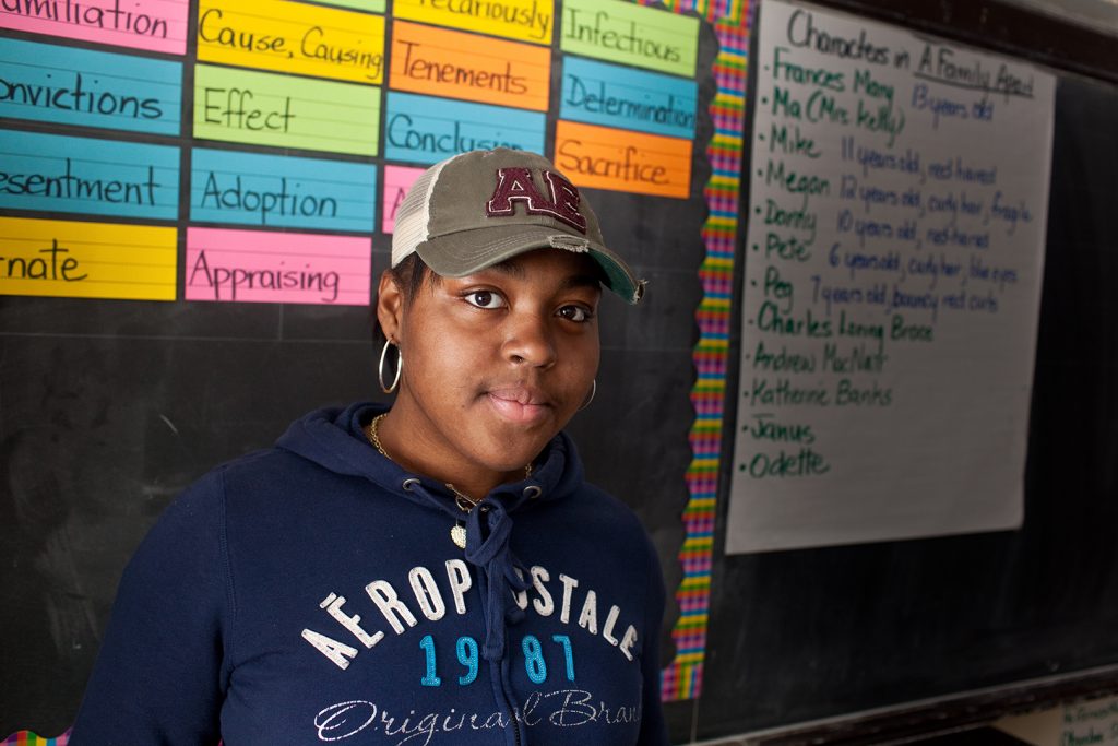 Girl in front of chalkboard at the Monroe Academy for Business and Law (MABL) in the South Bronx.